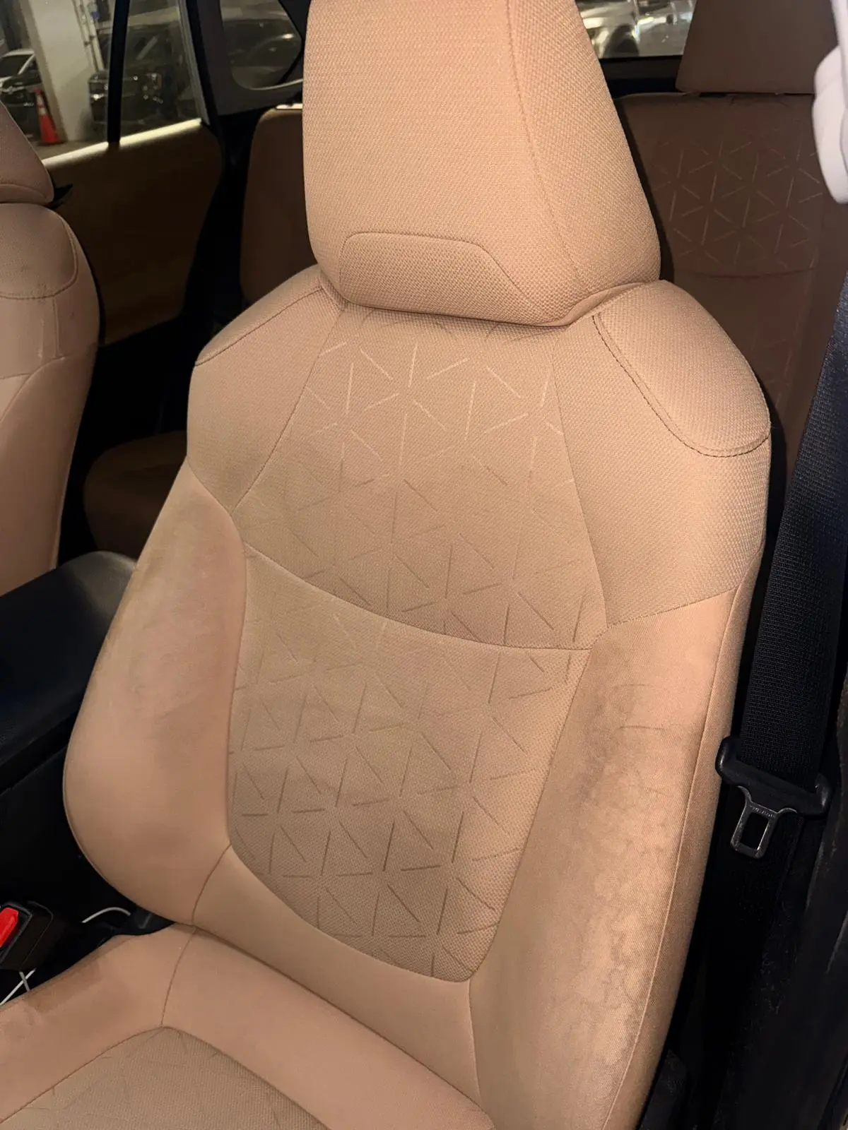 Before and after seat shampooing on SUV front seat in Fort Lauderdale — stains extracted by Route95 Mobile Car Detailing