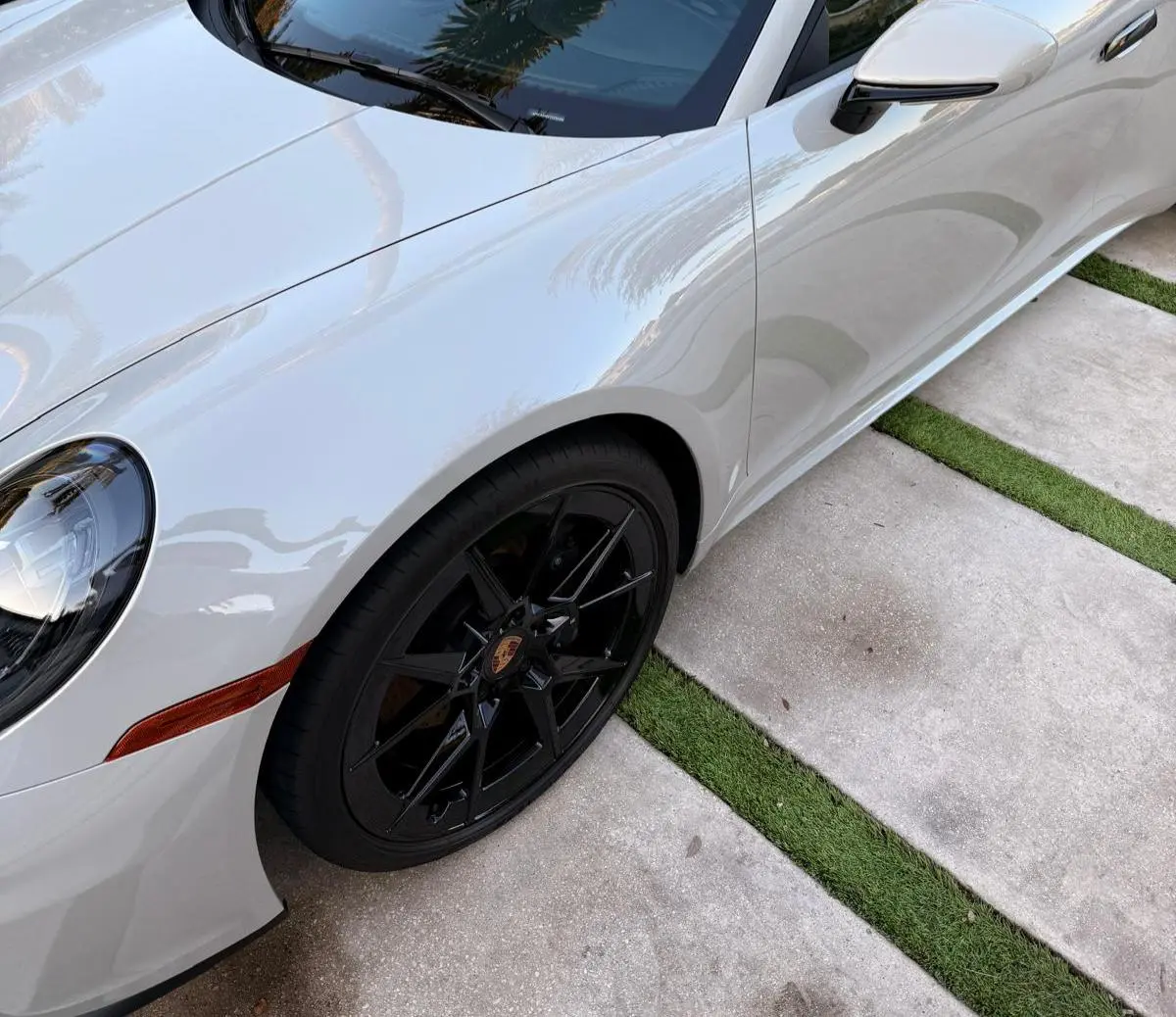 Before and after rim detail on Porsche 911 in Fort Lauderdale — professional wheel cleaning by Route95 Mobile Car Detailing