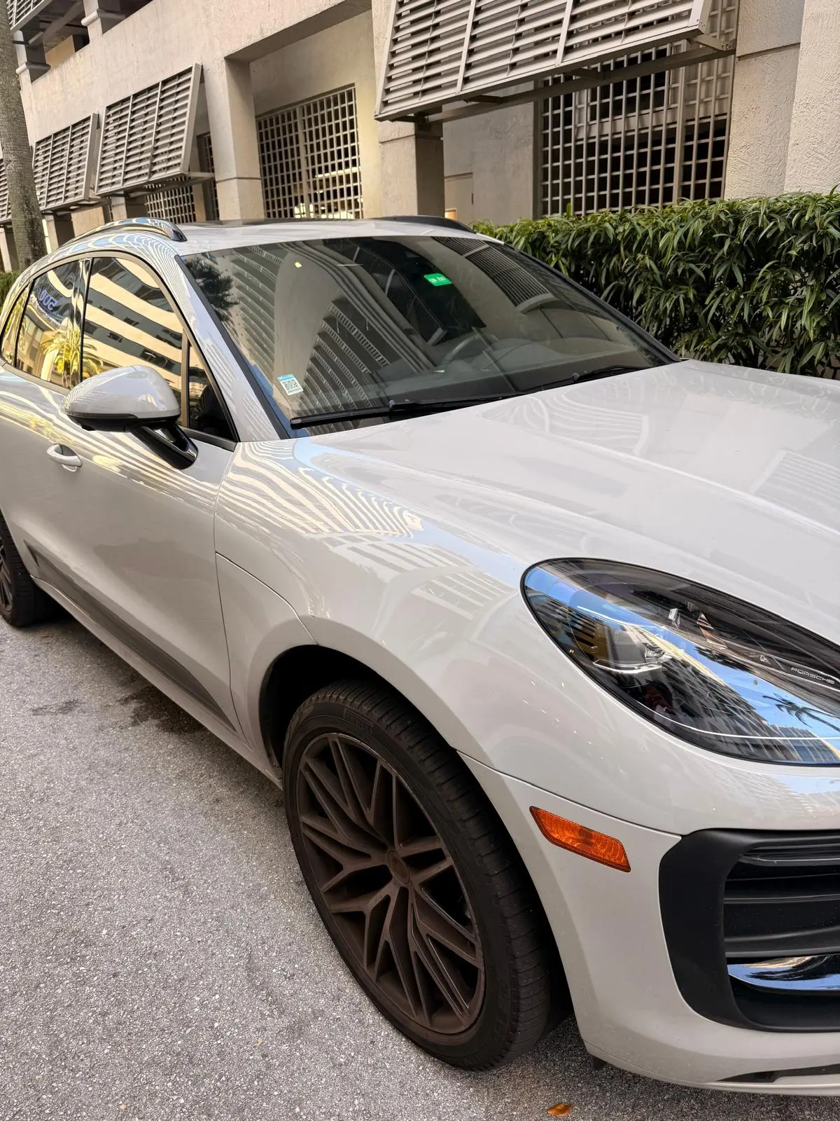 Before and after wheel cleaning on Porsche Macan in Fort Lauderdale — brake dust removed and rims restored by Route95