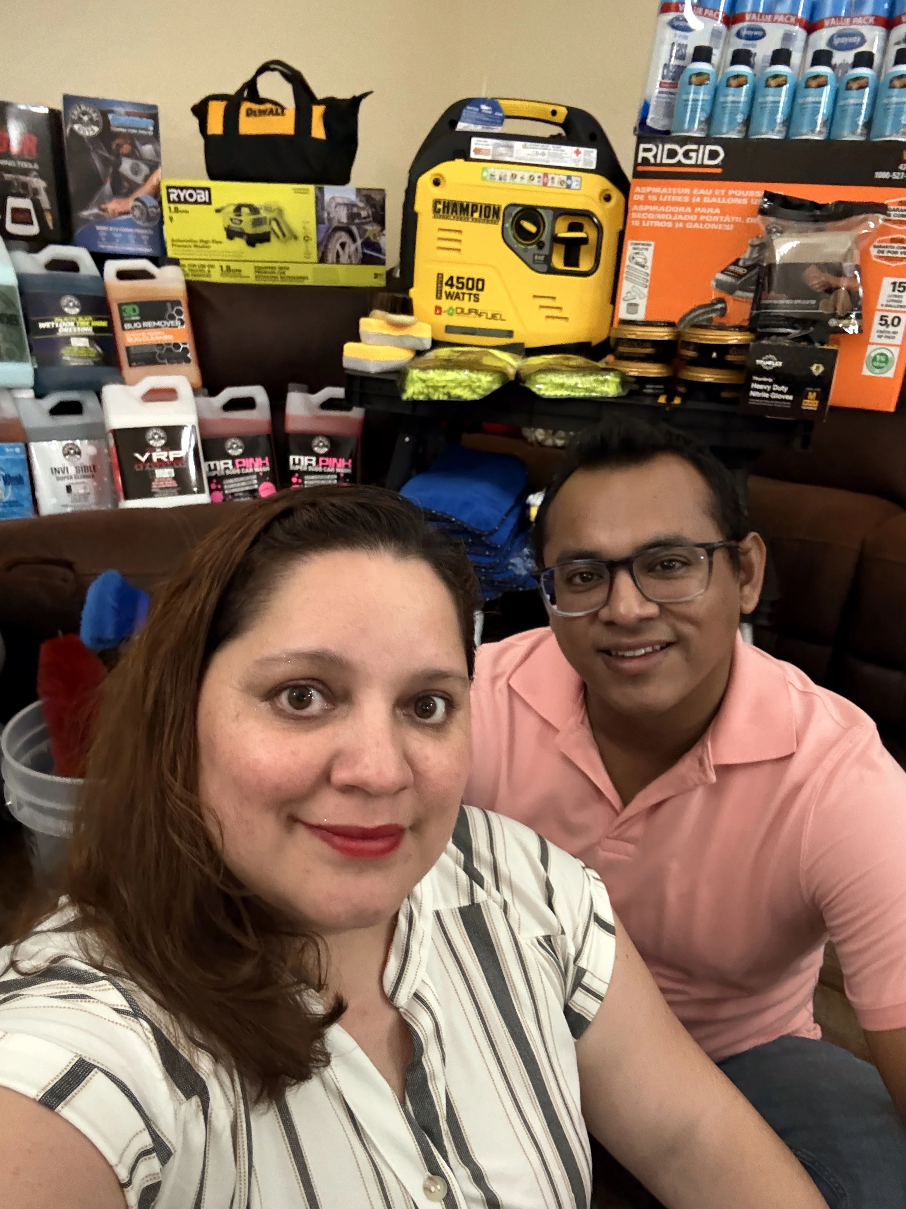 Route95 Mobile Car Detailing founders Gustavo Moya and Hazel Santillana with professional detailing equipment and products in Fort Lauderdale